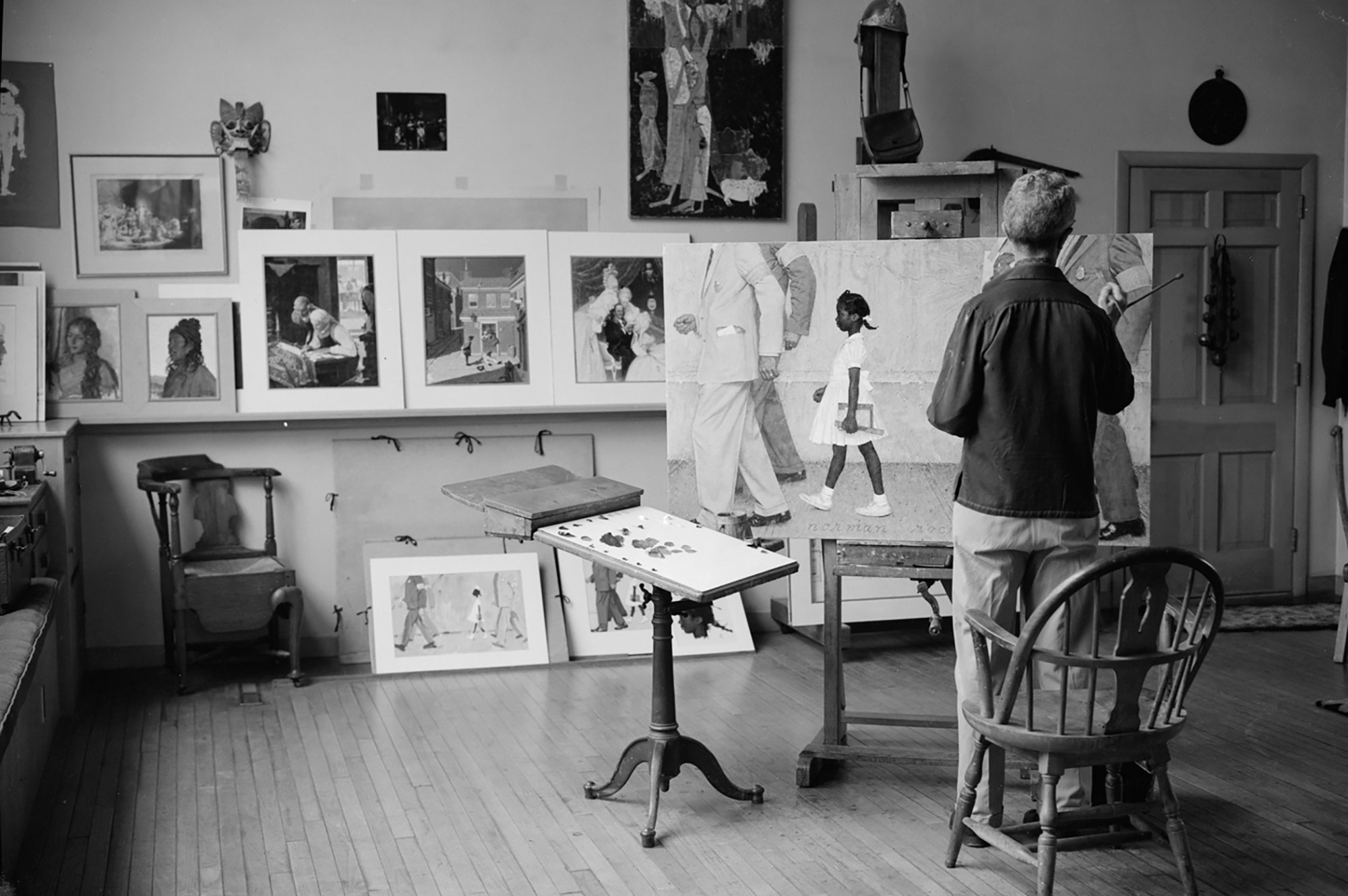 Norman Rockwell in his studio painting The Problem We All Live With