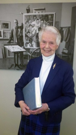 Norman Rockwell researcher Priscilla Anthony holding a copy of "Norman Rockwell: A Definitive Catalogue." Anthony helped to type and deliver the final manuscript of this comprehensive catalogue of Rockwell's work. Photo by Norman Rockwell Museum. All rights reserved.