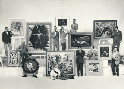 Group photo of Famous Artists School Faculty. Left to right: Harold von Schmidt, John Atherton, Al Parker, founder Al Dorne (white shirt, on ground), Norman Rockwell (with painting created for Cecil B. DeMille's 1949 film, "Samson and Delilah"), Ben Stahl, Peter Helck, Stevan Dohanos, Jon Whitcomb, Austin Briggs (rear, far right), and Robert Fawcett (front, far right). ©Norman Rockwell Museum Archives, gift of Famous Artists School. All rights reserved.